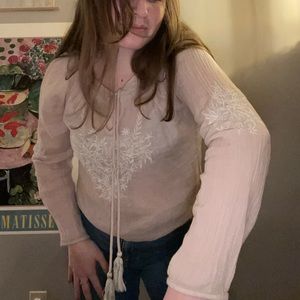 Elegant ballet slipper pink blouse with white flower embroidering.